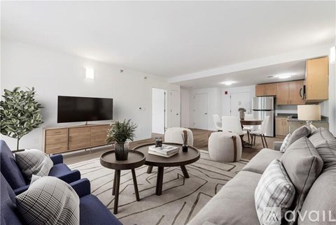 A living room with a grey couch and a wooden coffee table.