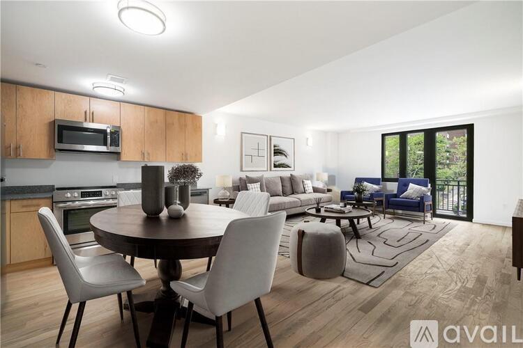 A modern kitchen with a dining table and chairs.