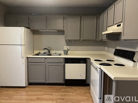A kitchen with a white refrigerator, a white stove, and a white dishwasher.