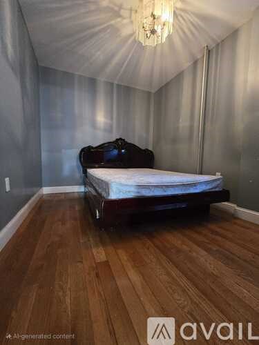 A bedroom with a bed and a chandelier.