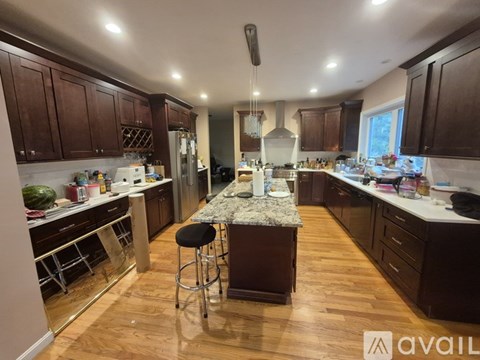 A kitchen with wooden cabinets and a central island.