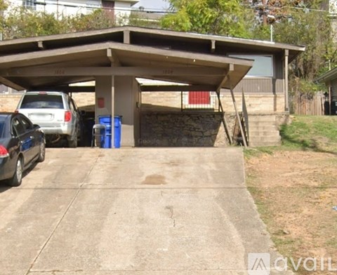 A carport with a car parked in front of it.