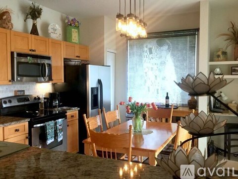 A kitchen with a table and chairs in the foreground.