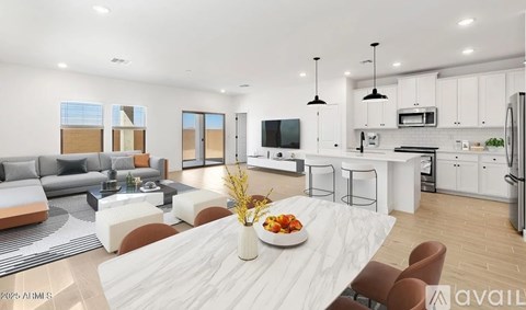A modern kitchen and living room with a dining table set in the middle.