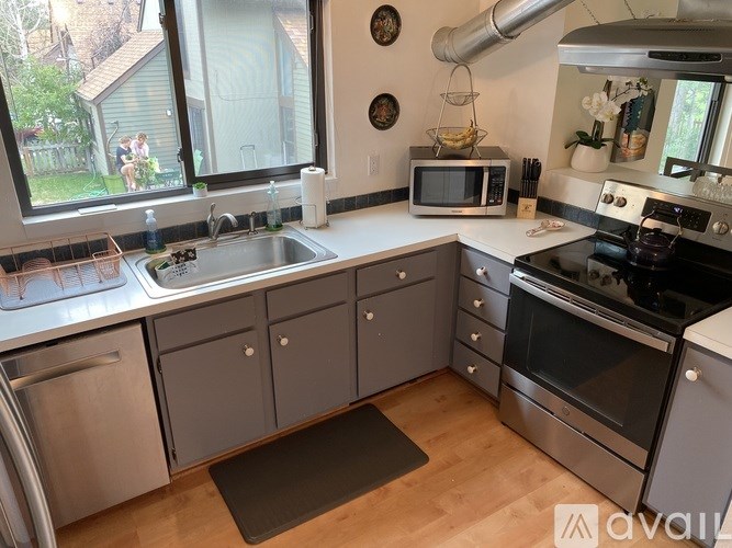A kitchen with a sink, stove, and oven.