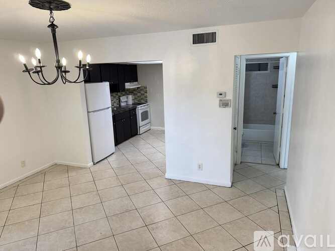 A bathroom with a toilet, sink, and shower.
