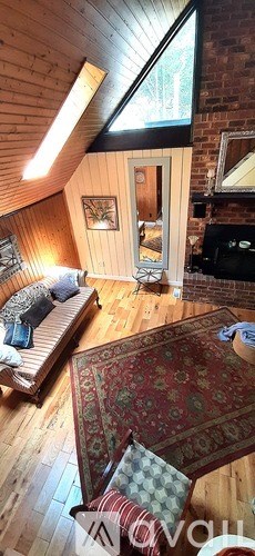 A living room with a couch and a rug.