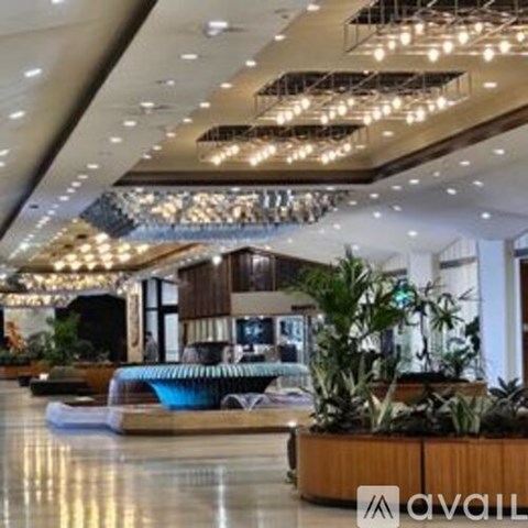 A large atrium with a pool table and a plant.