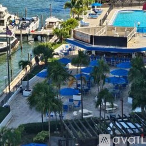 A cityscape with a bridge and a boat in the water.
