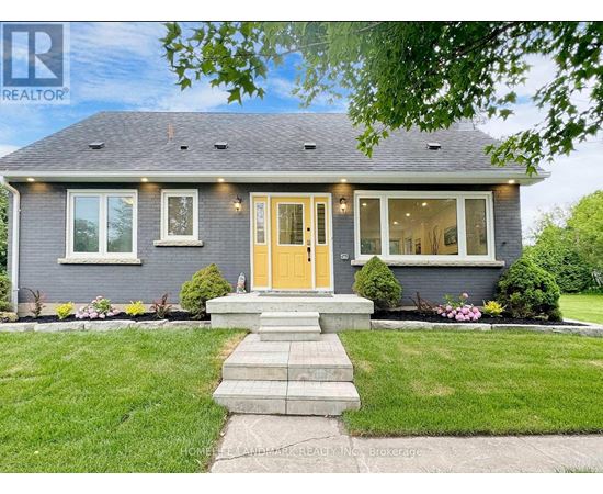 A house with a yellow door and a well-maintained lawn.