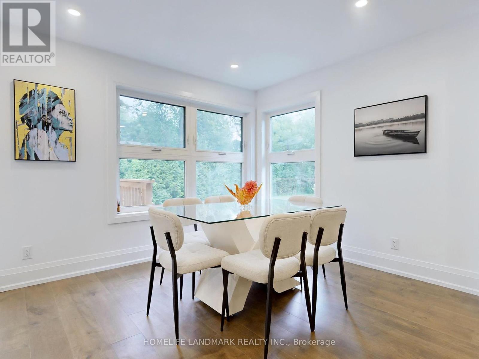 A dining room with a glass table and chairs.