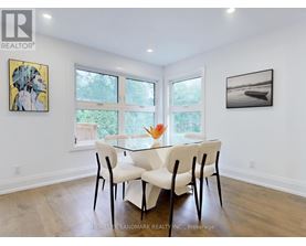 A dining room with a glass table and chairs.