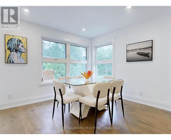 A dining room with a glass table and chairs.