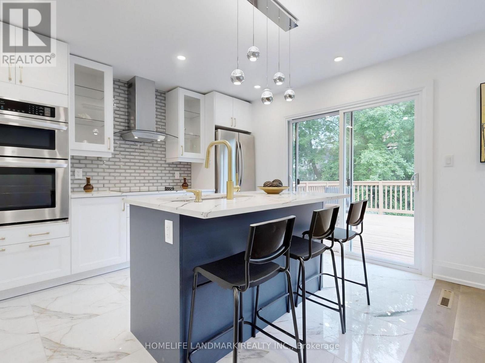 A kitchen with a large island and bar stools.