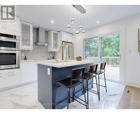 A kitchen with a large island and bar stools.