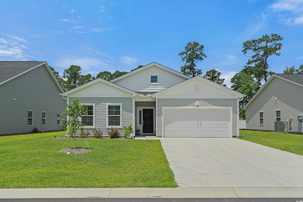 A house with a garage is surrounded by other similar houses.