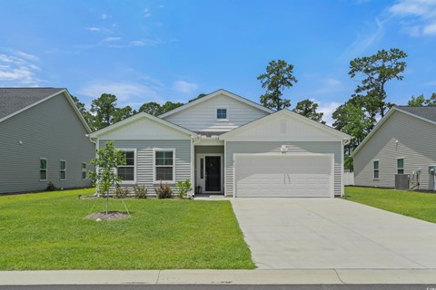 A house with a garage is surrounded by other similar houses.