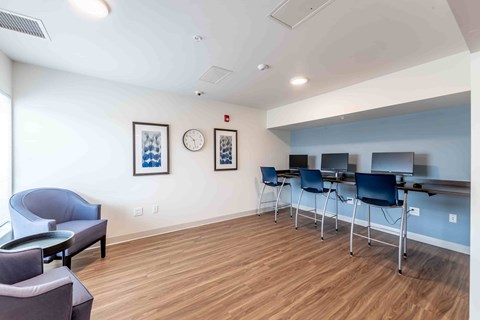 A conference room with a long table and chairs.