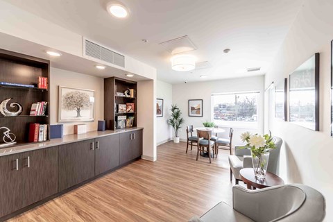 A living room with a grey sofa and a wooden floor.