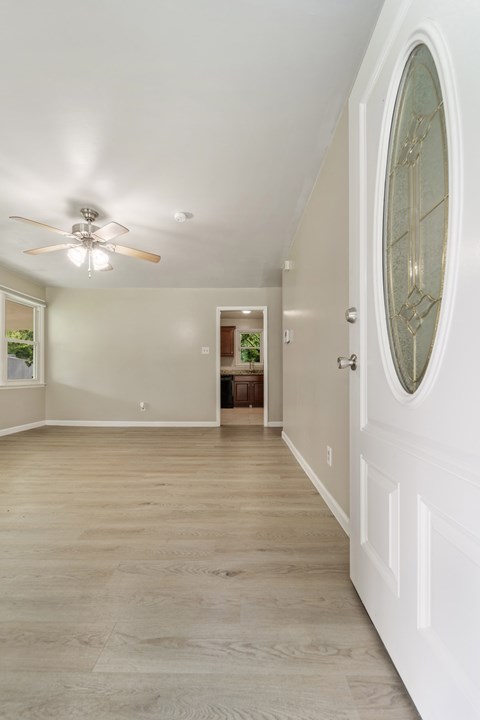 A white door with a glass window is on the right side of the room.