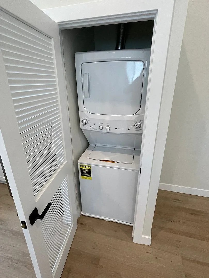 A small white refrigerator is tucked into a corner.