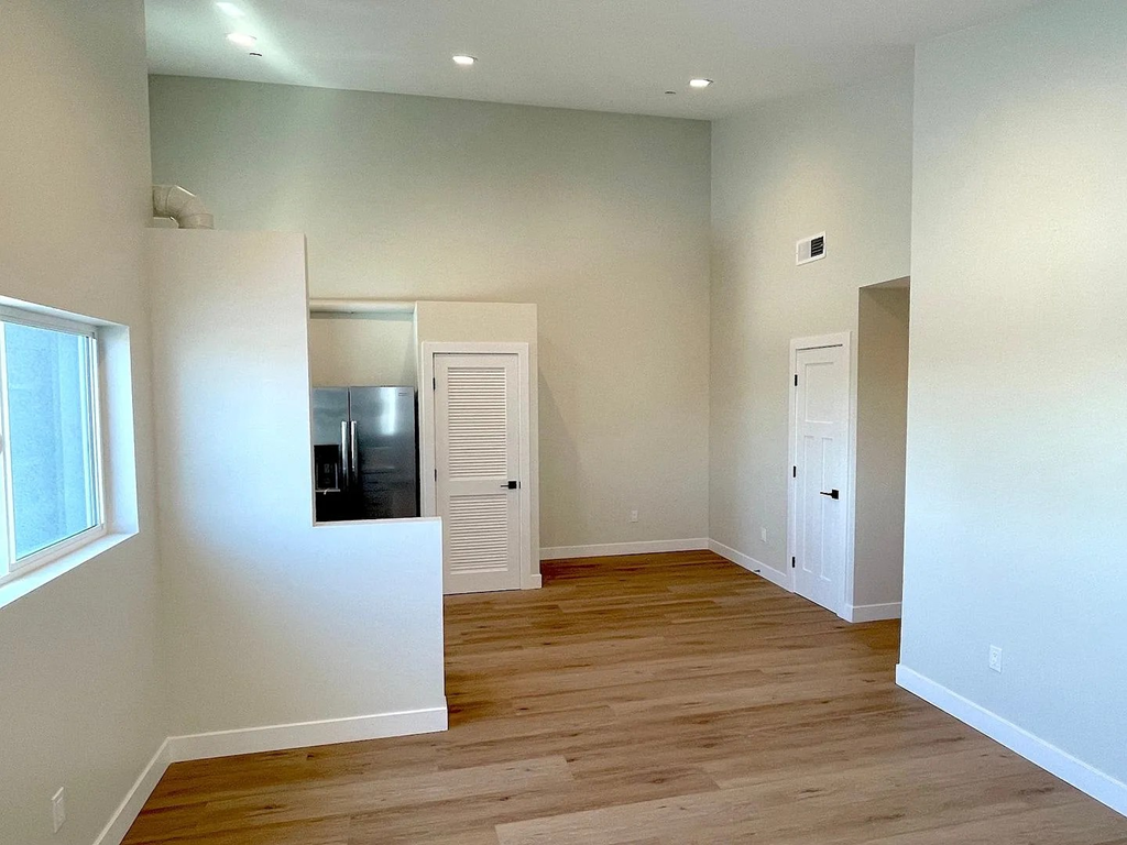 A room with wooden floors and white walls.