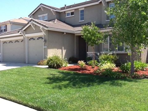 A house with a brown roof and a white garage door.