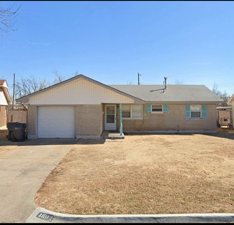 A house with a garage and a driveway.