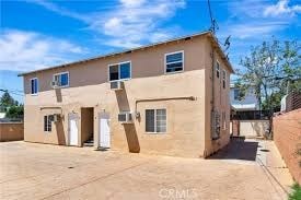A two-story house with a flat roof and a garage door.
