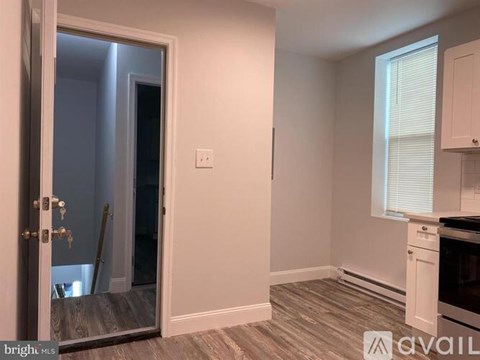 A kitchen area with a white oven and cabinets.
