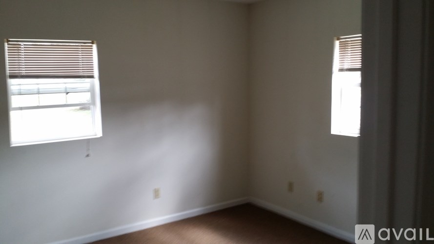 A room with a window on the left and a window on the right.