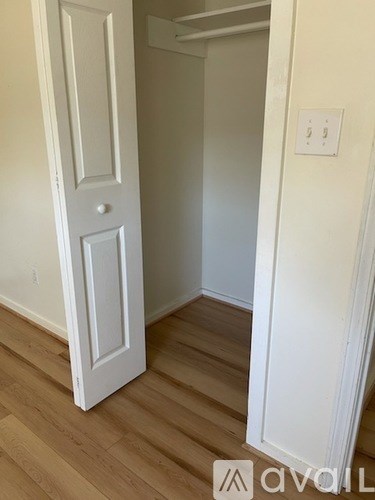 A white door is open to a hallway.