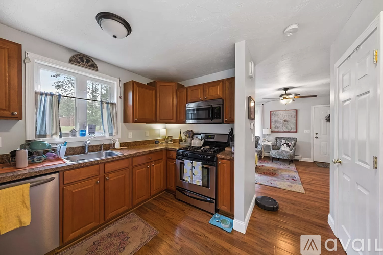 A kitchen with wooden cabinets and a stove top oven.