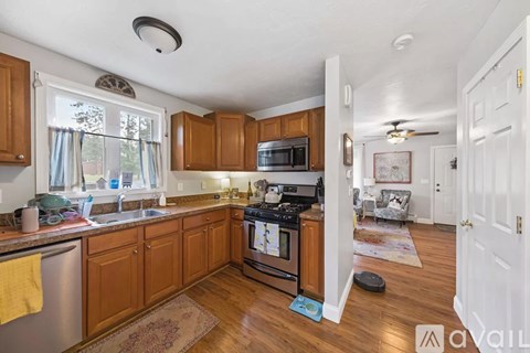 A kitchen with wooden cabinets and a stove top oven.