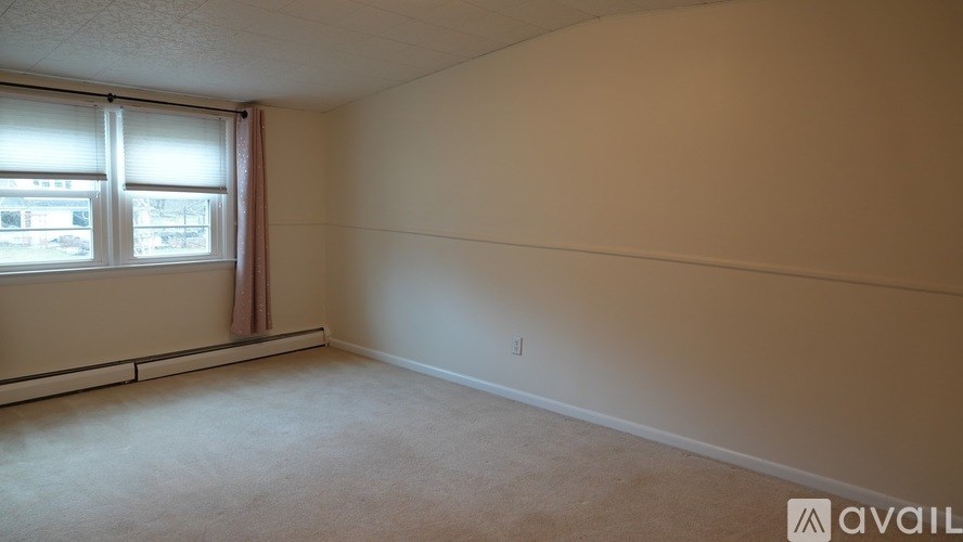 A room with a window and a wall with a line drawn on it.