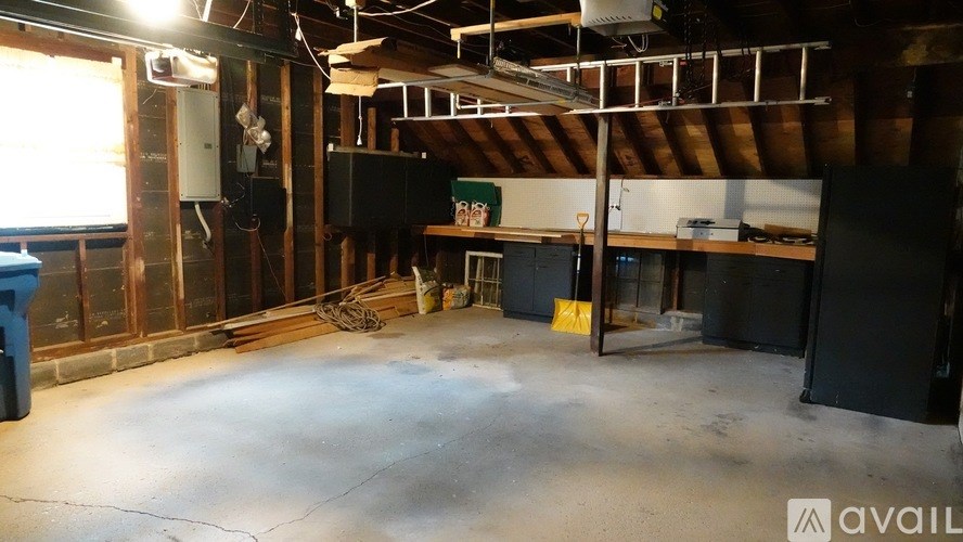 A large, empty warehouse with a concrete floor and exposed wooden beams.