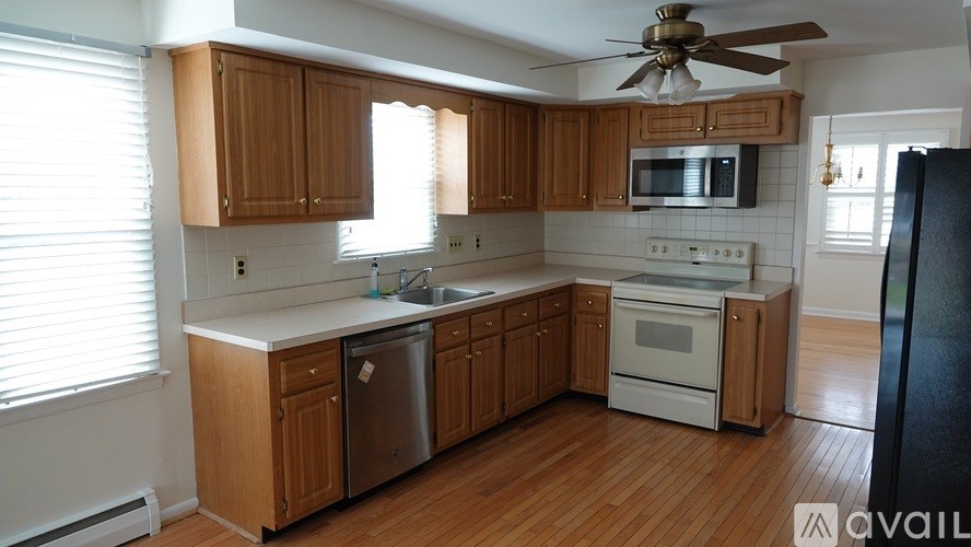 A kitchen with wooden cabinets and a white countertop.