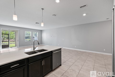 A kitchen with black cabinets and a white countertop.