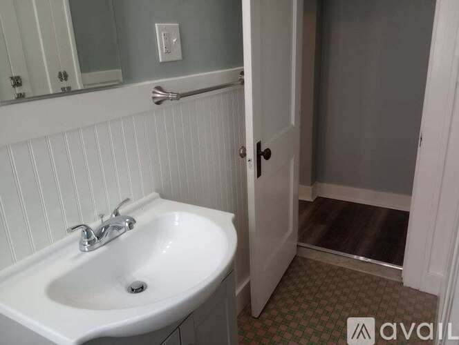 A bathroom with a sink and a mirror.
