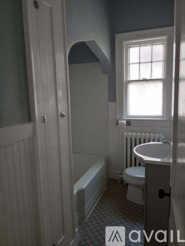 A bathroom with a toilet, sink, and bathtub.