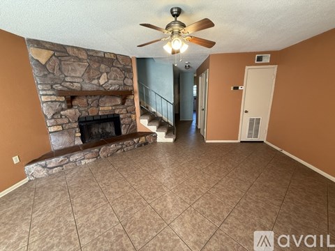 A room with a fireplace and a staircase.