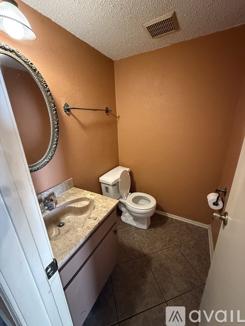 A room with a brown carpet and a white wall.