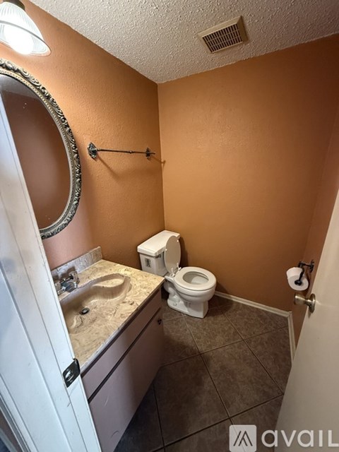 A room with a brown carpet and a white wall.