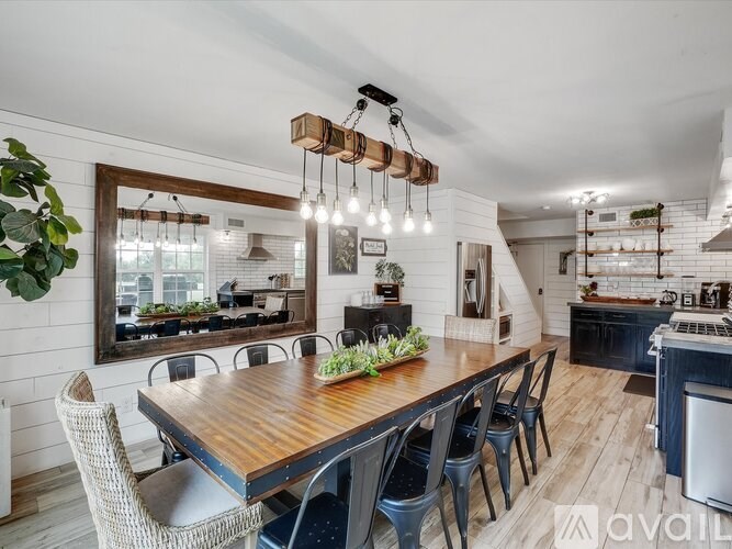 A modern dining room with a wooden table and chairs.