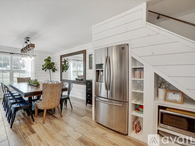 A kitchen with a dining table and chairs.