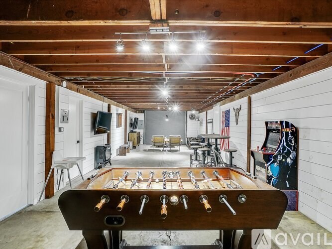 A foosball table is in the middle of a room with a wooden ceiling and walls.