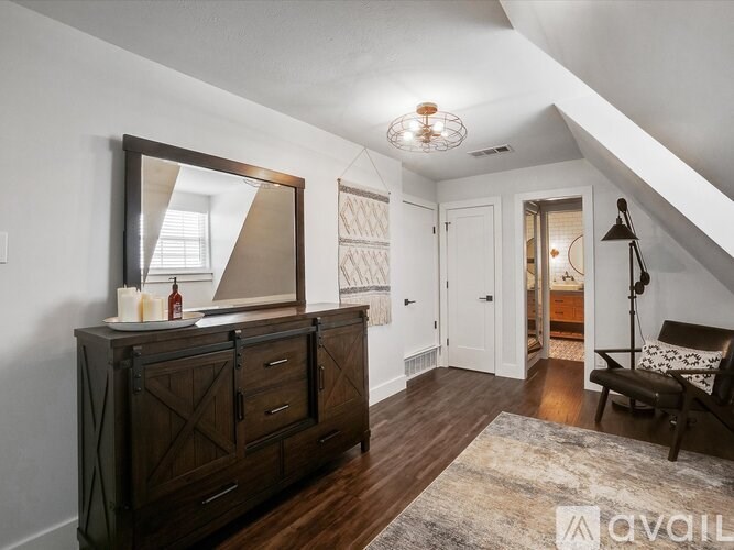 A bedroom with a dresser and a mirror.