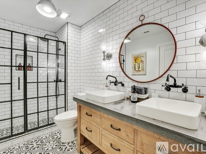 A bathroom with a white toilet, a sink, and a mirror.