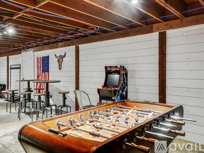 A foosball table is in the middle of a room with a wooden ceiling and walls.