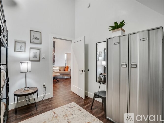 A room with a table, a chair, and a lamp.